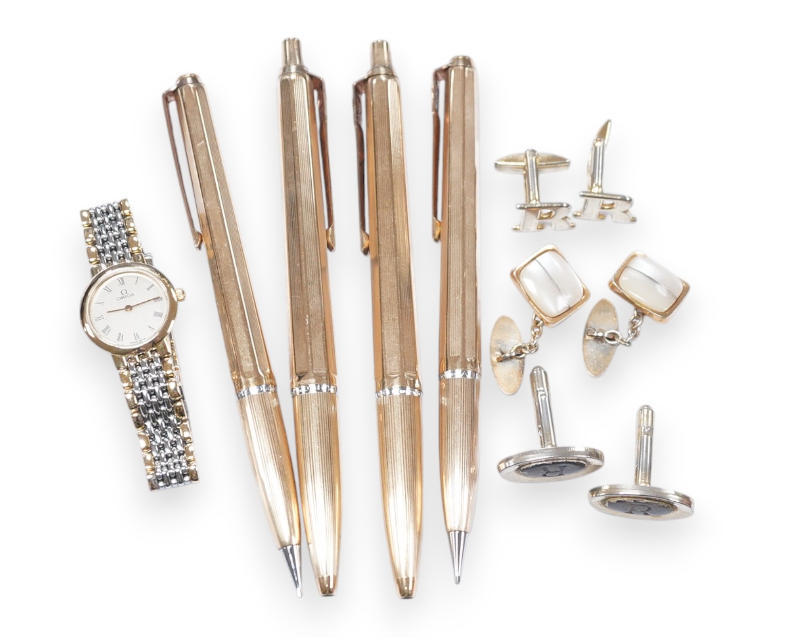 Sundry items comprising, four gold plated pens, cuff links, Omega lady's watch. Condition - fair to good